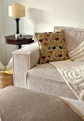 a couch with a pillow and a table with a lamp at Appart avec terrasse in Cannes