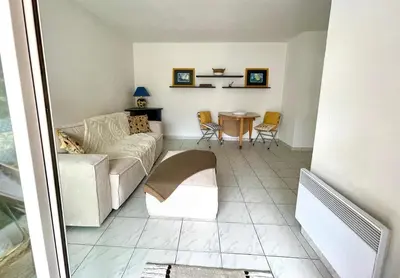 a living room with a couch and a table at Appart avec terrasse in Cannes