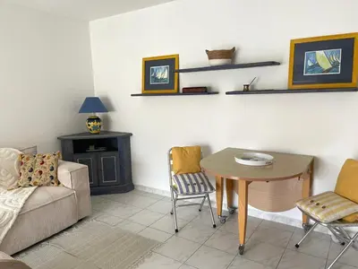 a living room with a couch and a table and chairs at Appart avec terrasse in Cannes