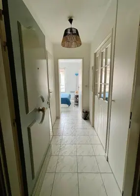 a hallway with a door and a tiled floor at Appart avec terrasse in Cannes