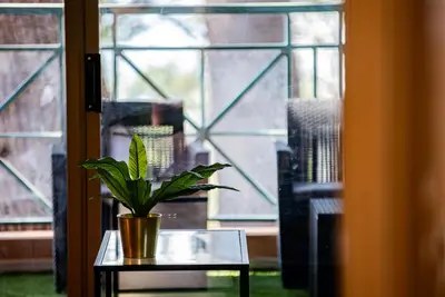 a potted plant sitting on a table in front of a window at Appartement de standing, Piscine, Tennis, Plage in Cannes