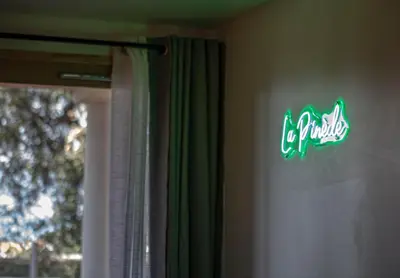a green sign on a wall next to a window at Appartement de standing, Piscine, Tennis, Plage in Cannes