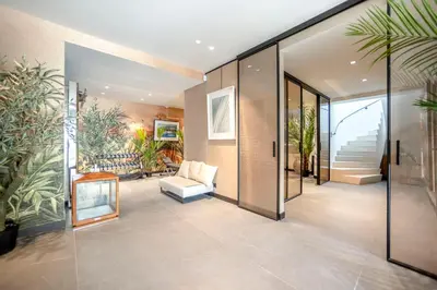 a living room with glass doors and plants at REF 2176 - Cannes -Villa panoramic sea view in Cannes