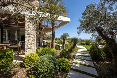 a garden with a walkway leading to a house at REF 2176 - Cannes -Villa panoramic sea view in Cannes