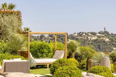 a garden with a gazebo and chairs and bushes at REF 2176 - Cannes -Villa panoramic sea view in Cannes