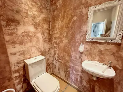 a bathroom with a toilet and a sink at 3-bedroom apartment on La Croisette with garden in Cannes