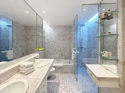 a bathroom with two sinks and a shower at 3-bedroom apartment on La Croisette with garden in Cannes