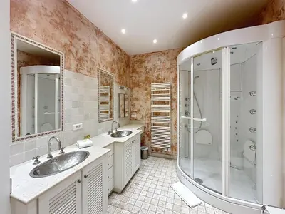 a bathroom with two sinks and a shower at 3-bedroom apartment on La Croisette with garden in Cannes