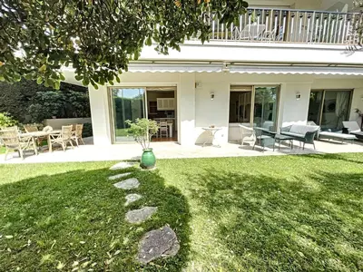 a house with a yard with a vase on the grass at 3-bedroom apartment on La Croisette with garden in Cannes
