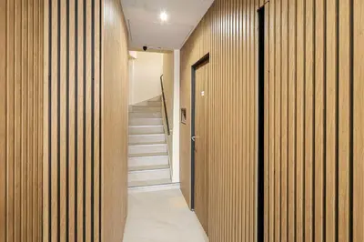a hallway with wood paneled walls and a staircase at Studio, centre ville Cannes in Cannes
