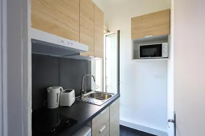 a small kitchen with a sink and a microwave at Studio, centre ville Cannes in Cannes