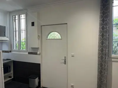 a white door in a kitchen with a window at Apparemment151 in Cannes
