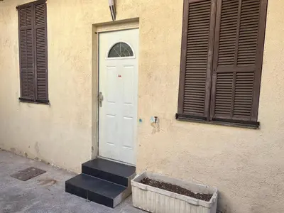 a white door on the side of a building at Apparemment151 in Cannes