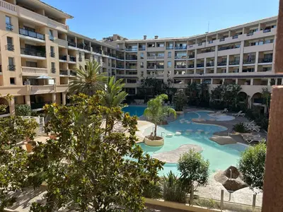 an apartment complex with a swimming pool and a resort at Le Beach 1 min plage , piscine , terrasse in Cannes
