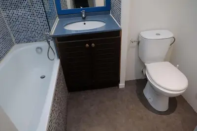 a bathroom with a toilet and a sink and a tub at Le Beach 1 min plage , piscine , terrasse in Cannes