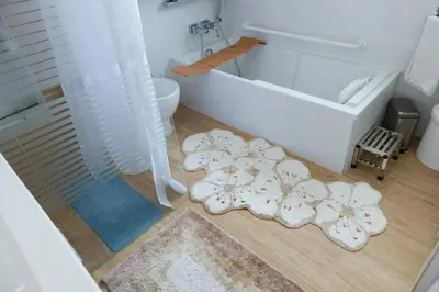 a bathroom with a tub and a rug at Beautiful renovated luxury apartment terrace parking in Cannes