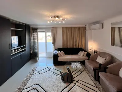 a living room with a couch and a table at Beautiful renovated luxury apartment terrace parking in Cannes