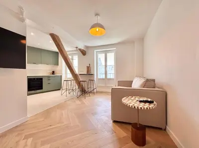 a living room with a couch and a kitchen at Cannes 1 bedroom apartment - FC8 in Cannes