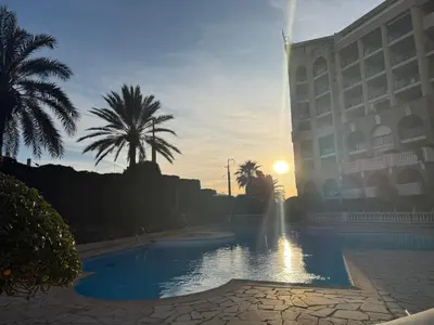 a hotel with a pool in front of a building at Palm d'Azur 459 in Cannes