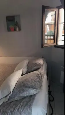 a bed with pillows on it in a bedroom at Palm d'Azur 459 in Cannes