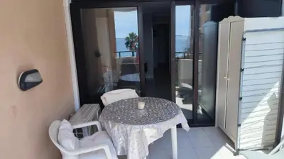 a table and chairs on a balcony with a table at Palm d'Azur 459 in Cannes
