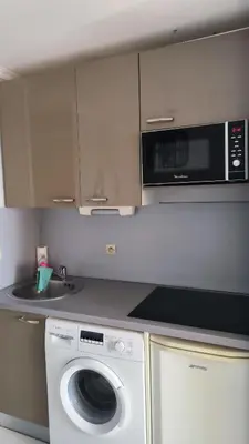 a kitchen with a washing machine and a microwave at Palm d'Azur 459 in Cannes
