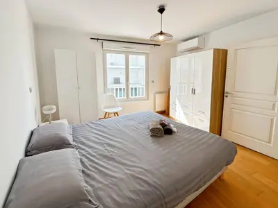a bedroom with a large bed and a closet at CAM103 - Beau 2 pièces avec terrasse in Cannes