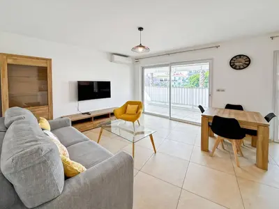 a living room with a couch and a table at CAM103 - Beau 2 pièces avec terrasse in Cannes