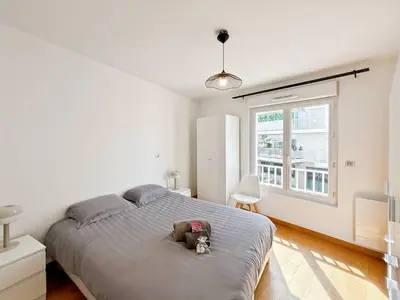 a bedroom with a bed with a stuffed animal on it at CAM103 - Beau 2 pièces avec terrasse in Cannes