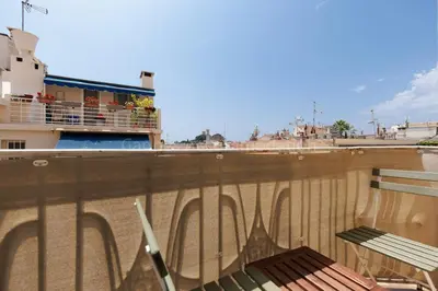 a balcony with a bench on top of a building at Soeur in Cannes