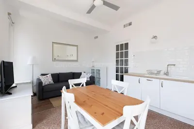 a kitchen and living room with a table and a couch at Soeur in Cannes