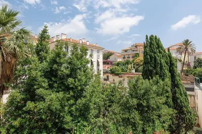 a group of trees in front of a building at Soeur in Cannes