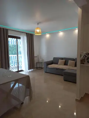 a living room with a couch and a table at Cannes 5min plages in Cannes