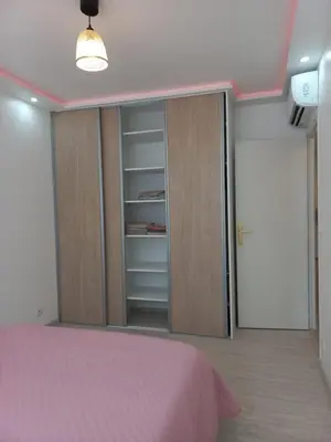 a bedroom with a pink bed and a closet at Cannes 5min plages in Cannes