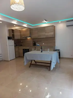 a kitchen with a table with a white table cloth on it at Cannes 5min plages in Cannes