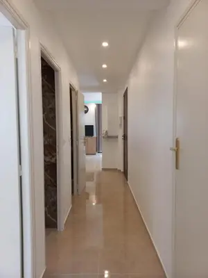 a hallway of a house with white walls and wooden floors at Cannes 5min plages in Cannes