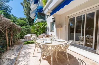 a table and chairs on the patio of a house at Ground-Floor Apartment with Private Garden Cannes in Cannes