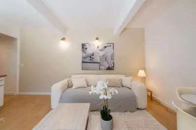 a living room with a couch and a table at Ground-Floor Apartment with Private Garden Cannes in Cannes
