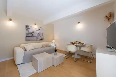 a living room with a couch and a table at Ground-Floor Apartment with Private Garden Cannes in Cannes