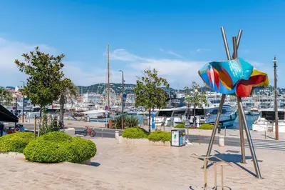 a colorful sculpture in a park with a marina at Le 45 Clémenceau - Superbe logement proche plages et Palais in Cannes