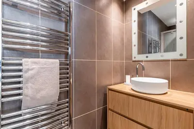 a bathroom with a sink and a mirror at Le 45 Clémenceau - Superbe logement proche plages et Palais in Cannes