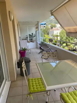 a balcony with a table and chairs on a building at Prince de Galles in Cannes