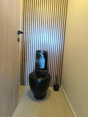 a bathroom with a black toilet with a tv on it at 3-room air-conditioned terrace, sea view in Cannes