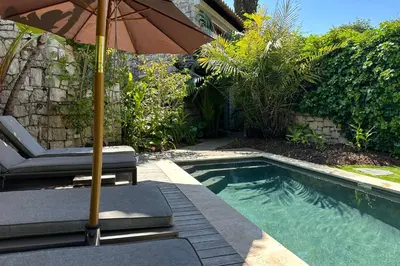 a swimming pool with an umbrella and a chaise lounge and sidx sidx at Cannes - Villa for rent - 2179 in Cannes