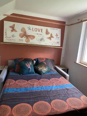 a bedroom with a bed with alove sign on the wall at Villa piscine cannes 2 chambres in Cannes