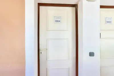 a white door with two signs on it at Résidence Cannes Villa Francia - maeva Home - Appartement climatisé 2 pièces 4 personnes - Prestige - super Home MAE-1343 in Cannes
