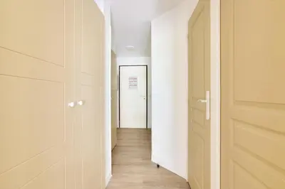 an empty corridor with a door and a hallway with a hallway at Résidence Cannes Villa Francia - maeva Home - Appartement climatisé 2 pièces 4 personnes - Prestige - super Home MAE-1343 in Cannes