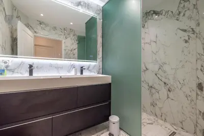 a bathroom with a sink and a mirror at LB Vacation Rentals I Elegant Apartment with Terrace & Mezzanine in the heart of Cannes in Cannes
