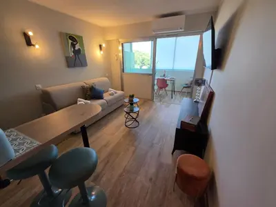 a living room with a couch and a table at Apartment Les Sablons-3 by Interhome in Cannes