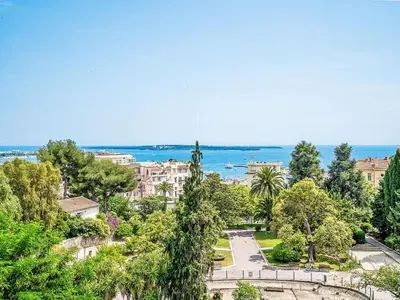 a view of a park with trees and buildings at Apartment Cannes Parc-2 by Interhome in Cannes